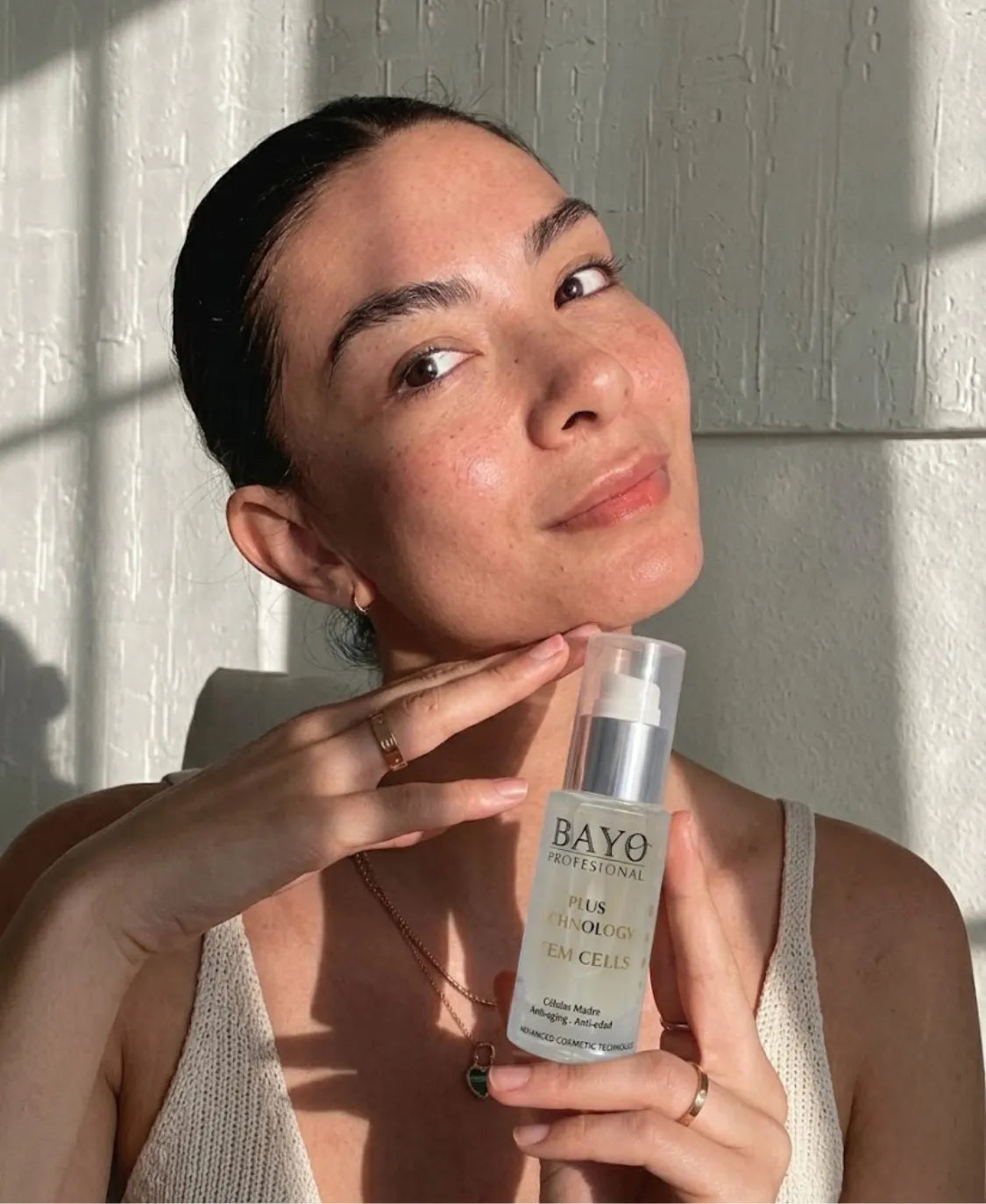 Mujer sosteniendo un sérum facial de PASABELU bajo la luz natural